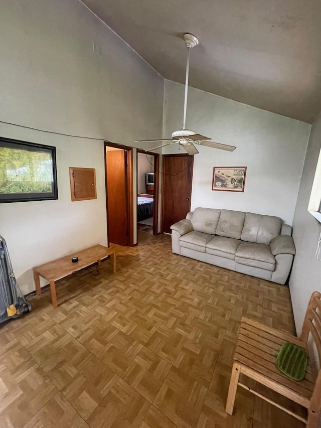 unfurnished living room with ceiling fan, high vaulted ceiling, and light parquet flooring