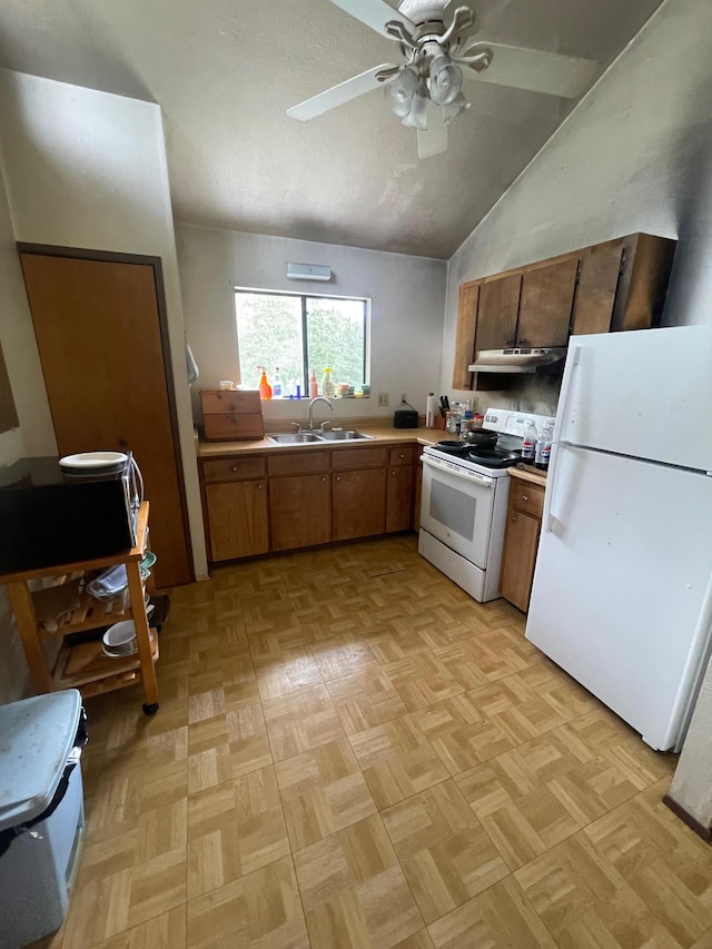 kitchen featuring white appliances, light parquet floors, ceiling fan, vaulted ceiling, and sink