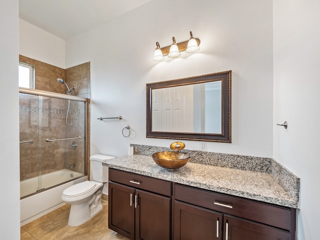 full bathroom with enclosed tub / shower combo, tile flooring, vanity, and toilet