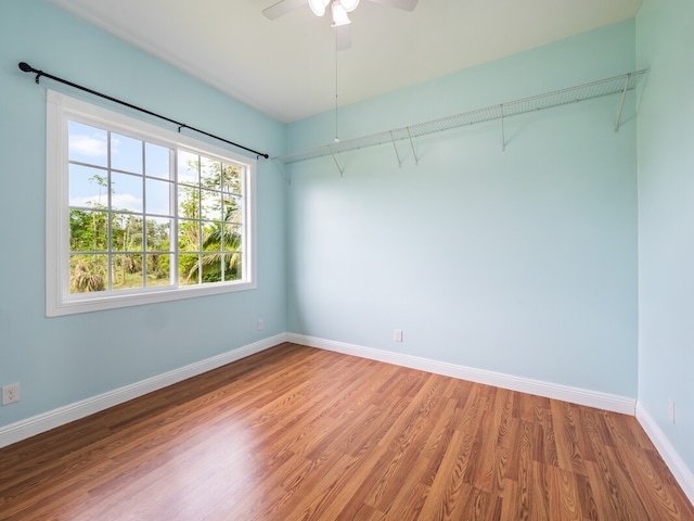 empty room with wood-type flooring and ceiling fan