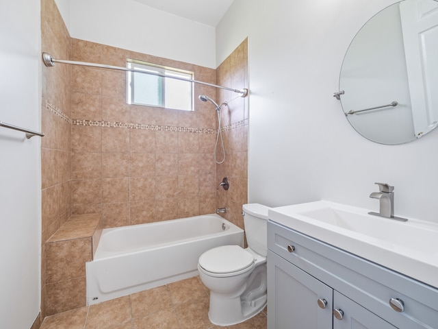 full bathroom featuring tiled shower / bath, tile flooring, toilet, and vanity