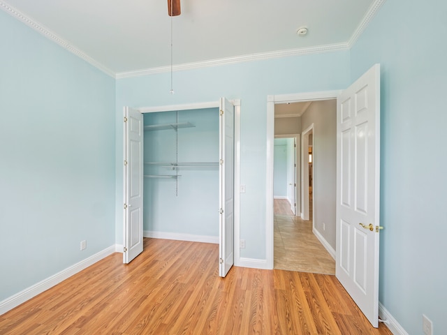 unfurnished bedroom with ornamental molding, light hardwood / wood-style floors, and a closet