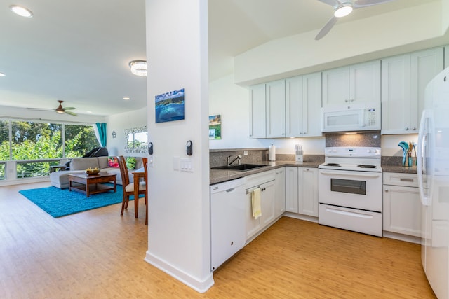 kitchen with sink, light hardwood / wood-style flooring, backsplash, white appliances, and white cabinets