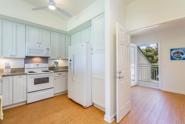 kitchen with white cabinetry, light wood-type flooring, and white appliances