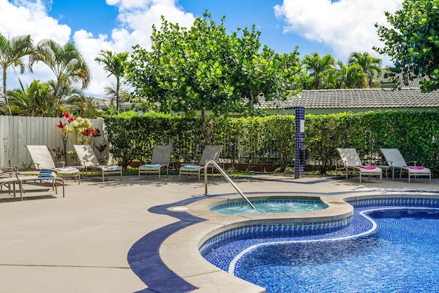 view of swimming pool with an in ground hot tub and a patio