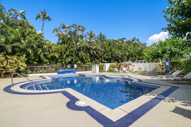 view of swimming pool featuring an in ground hot tub and a patio area