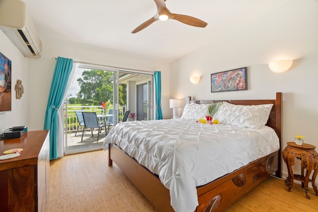 bedroom with access to outside, a wall mounted AC, ceiling fan, and light wood-type flooring