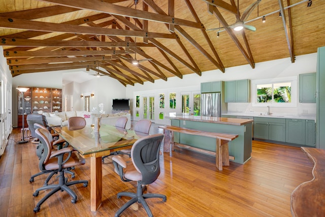 office space with light wood-type flooring, wood ceiling, sink, beam ceiling, and high vaulted ceiling