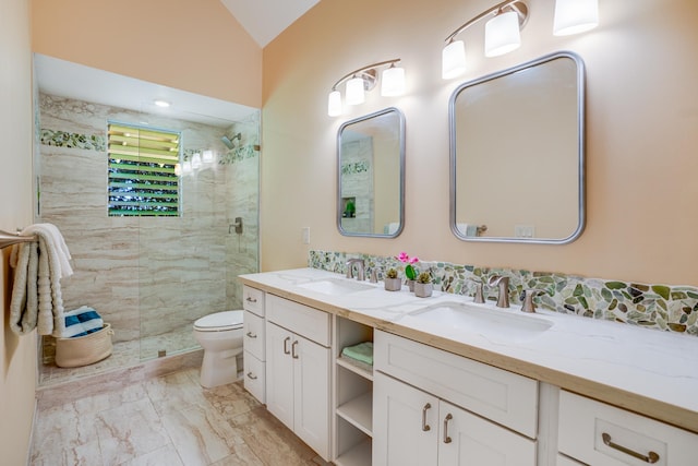 bathroom featuring vanity, toilet, a shower with shower door, and lofted ceiling