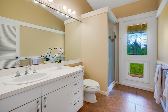 bathroom featuring walk in shower, vanity, toilet, and a wealth of natural light