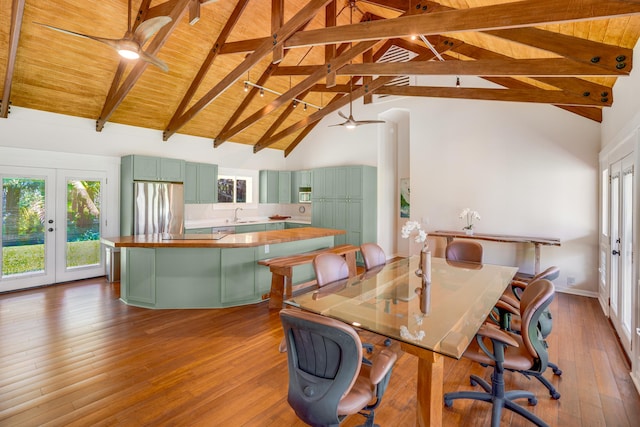 dining area with beam ceiling, high vaulted ceiling, french doors, and wooden ceiling