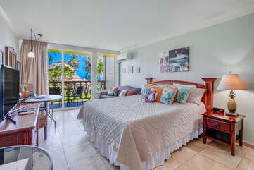 bedroom featuring a wall mounted air conditioner, access to exterior, a wall of windows, and light tile patterned floors