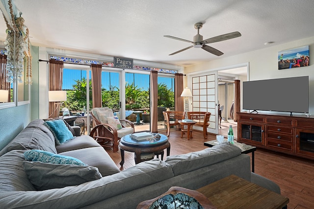 living room with a textured ceiling, french doors, ceiling fan, and hardwood / wood-style floors