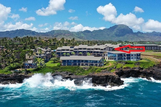 birds eye view of property with a water and mountain view