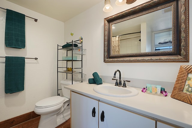 bathroom with toilet, vanity, hardwood / wood-style flooring, and a shower with curtain