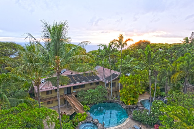 view of pool at dusk