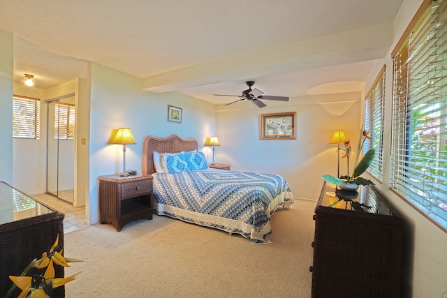 bedroom featuring carpet, a textured ceiling, and ceiling fan