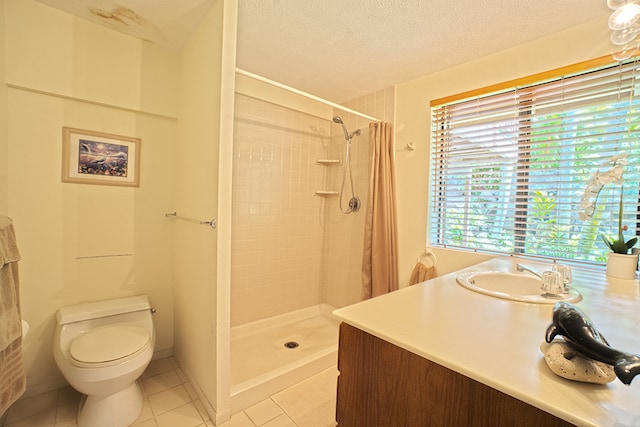 bathroom featuring a textured ceiling, toilet, vanity, tile patterned floors, and curtained shower