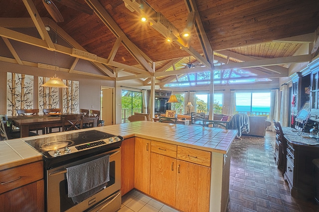 kitchen with electric stove, ceiling fan, lofted ceiling with beams, tile counters, and wood ceiling