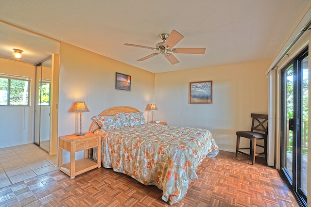 bedroom featuring access to outside, ceiling fan, and parquet flooring