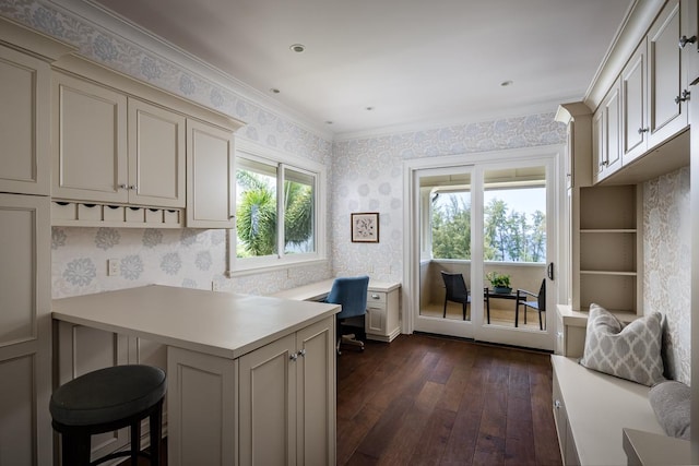 office featuring ornamental molding, dark wood-style flooring, and wallpapered walls