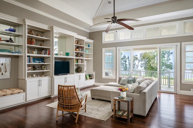 living room featuring a wealth of natural light, ceiling fan, and dark hardwood / wood-style floors