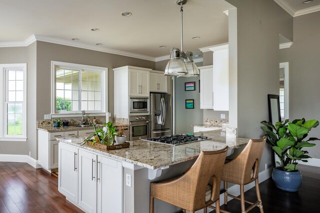 kitchen featuring white cabinetry, kitchen peninsula, dark hardwood / wood-style flooring, stainless steel appliances, and ornamental molding