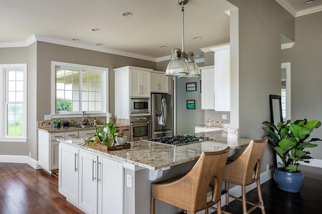 kitchen with light stone counters, stainless steel appliances, white cabinetry, dark wood finished floors, and pendant lighting