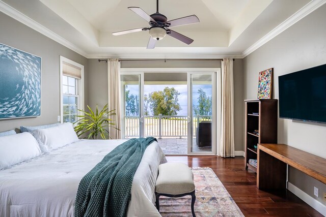 bedroom with crown molding, access to outside, ceiling fan, a tray ceiling, and dark hardwood / wood-style floors