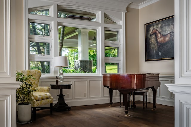 interior space with dark hardwood / wood-style flooring and ornamental molding