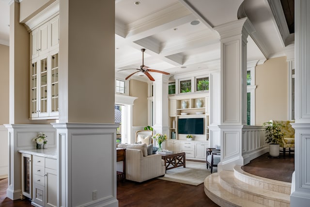 living room with coffered ceiling, ceiling fan, crown molding, and dark wood-type flooring