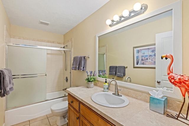 full bathroom featuring tile patterned flooring, vanity, bath / shower combo with glass door, and toilet