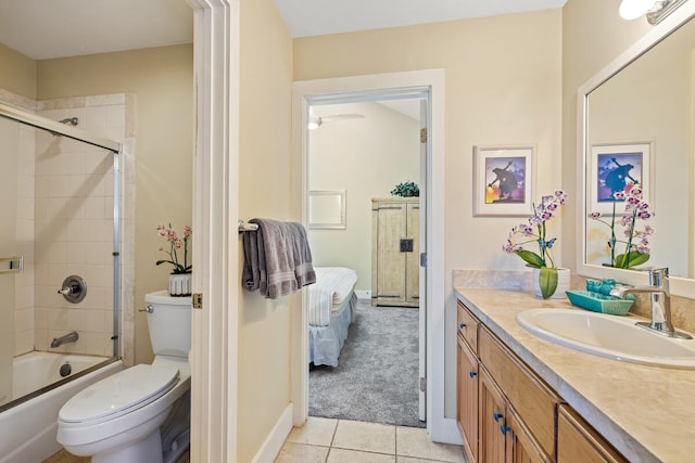 full bathroom featuring tile patterned flooring, vanity, toilet, and bath / shower combo with glass door