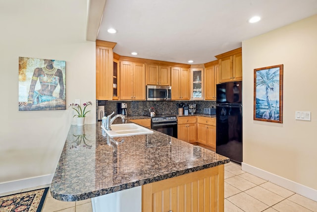 kitchen featuring light tile patterned floors, kitchen peninsula, sink, and appliances with stainless steel finishes