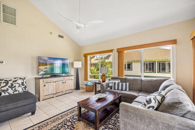 tiled living room featuring ceiling fan and high vaulted ceiling