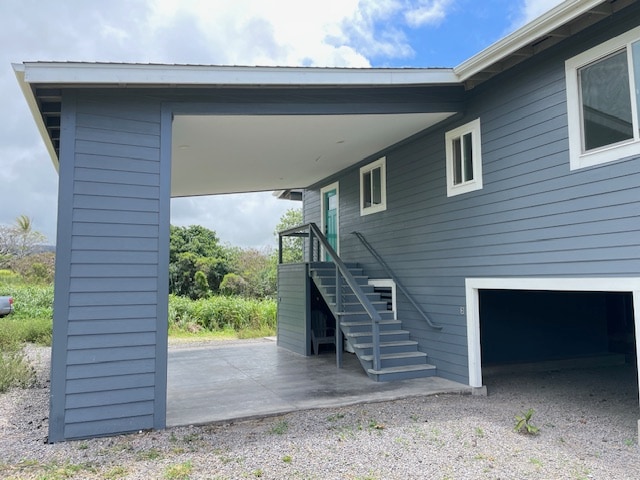 doorway to property featuring a garage and a carport