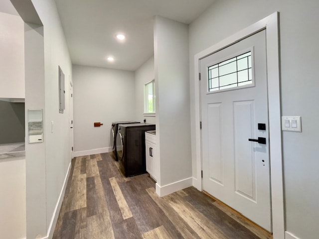 interior space featuring washing machine and dryer, dark hardwood / wood-style flooring, cabinets, and electric panel