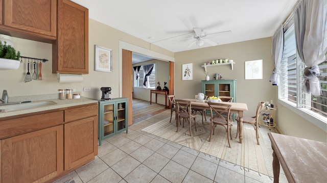 kitchen with ceiling fan, light tile patterned floors, and sink