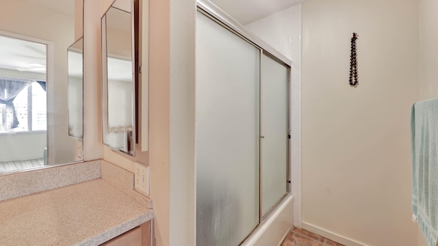 bathroom with shower / bath combination with glass door