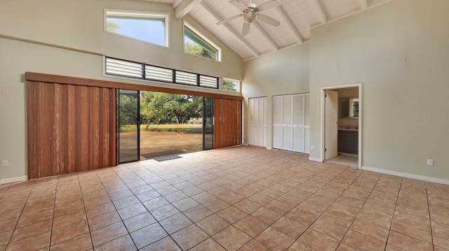 spare room featuring beamed ceiling, high vaulted ceiling, ceiling fan, and light tile patterned flooring