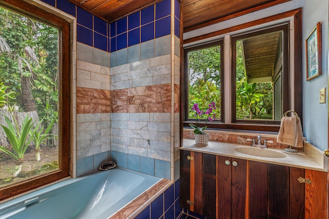 bathroom with vanity, tiled tub, and wooden ceiling