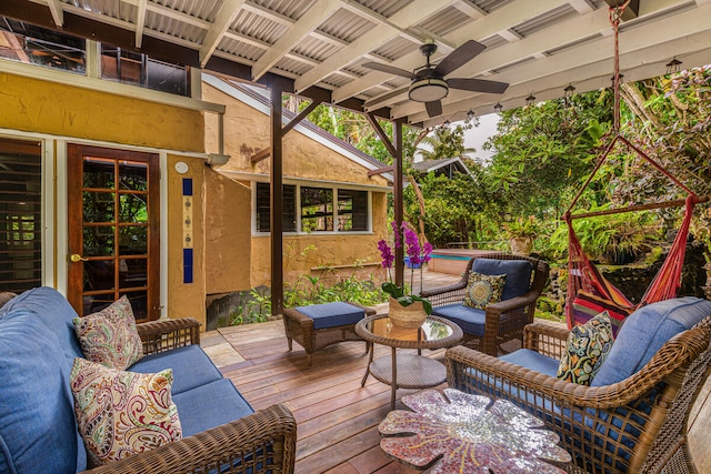 deck with outdoor lounge area and ceiling fan