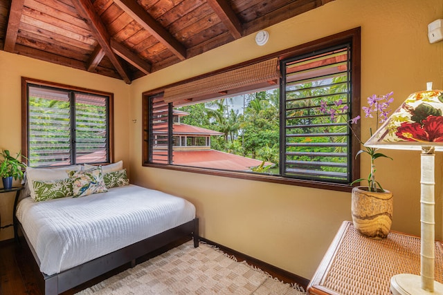 bedroom featuring hardwood / wood-style flooring, vaulted ceiling with beams, and wood ceiling