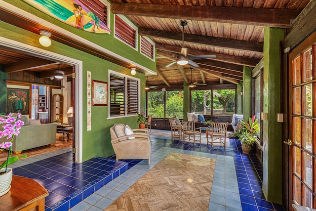 sunroom featuring ceiling fan, vaulted ceiling with beams, and wooden ceiling