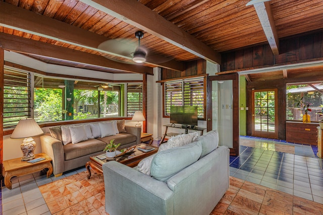 tiled living room with wood ceiling, wooden walls, beamed ceiling, and ceiling fan