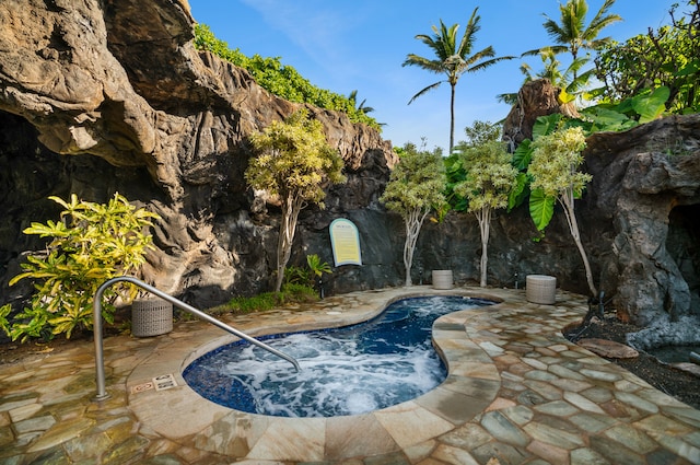 view of pool with a patio and an in ground hot tub