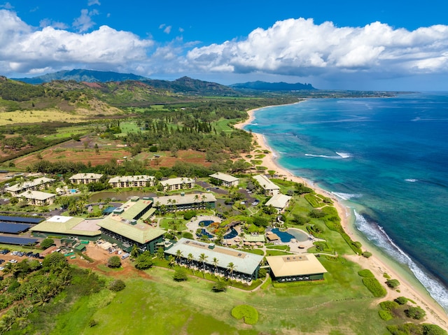 birds eye view of property featuring a water and mountain view and a beach view