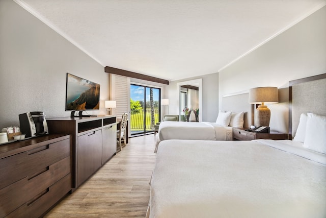 bedroom featuring crown molding, light wood-type flooring, and access to exterior