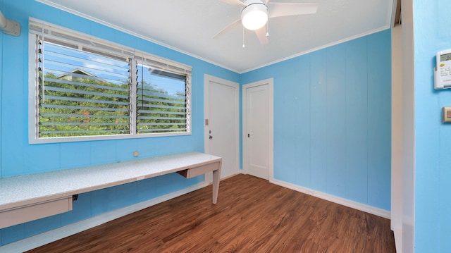 interior space featuring ceiling fan, ornamental molding, and dark wood-type flooring