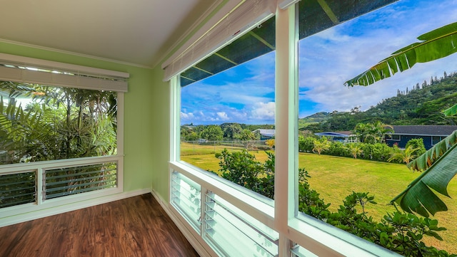 unfurnished sunroom with ceiling fan